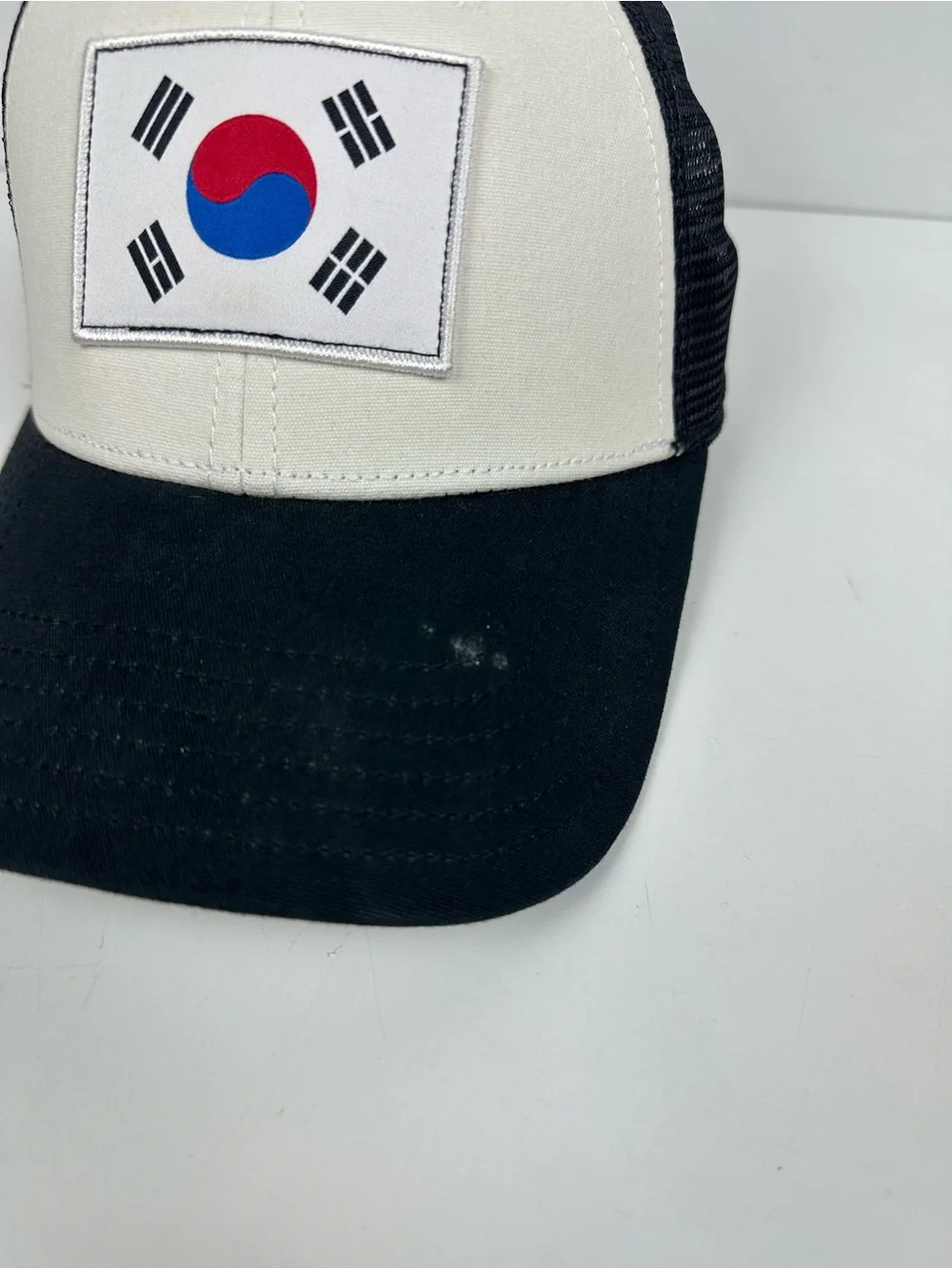 The North Face Black & White Trucker Hat with South Korea Flag Patch